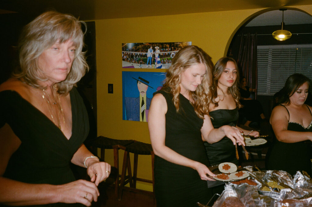 Guests serving themselves tacos from a buffet at a Las Vegas retro film elopement reception.