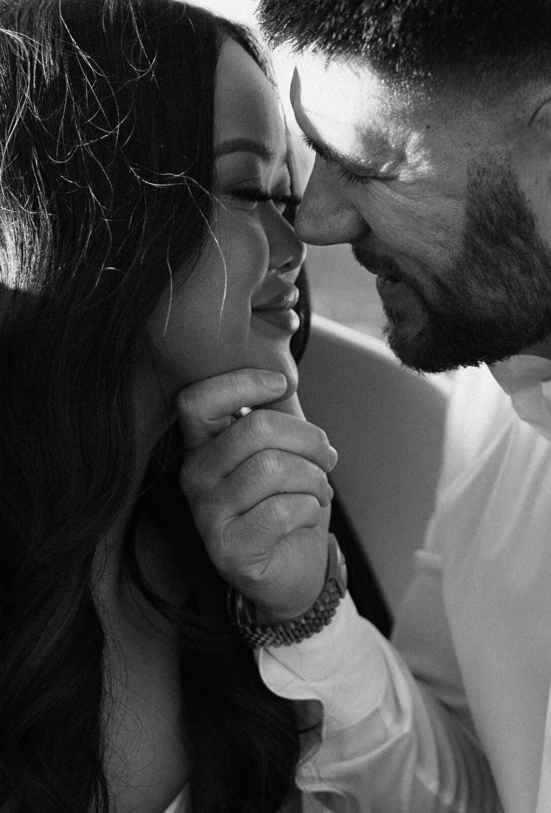 Intimate black-and-white close-up of the couple smiling nose-to-nose during their Red Rock Canyon engagement session.