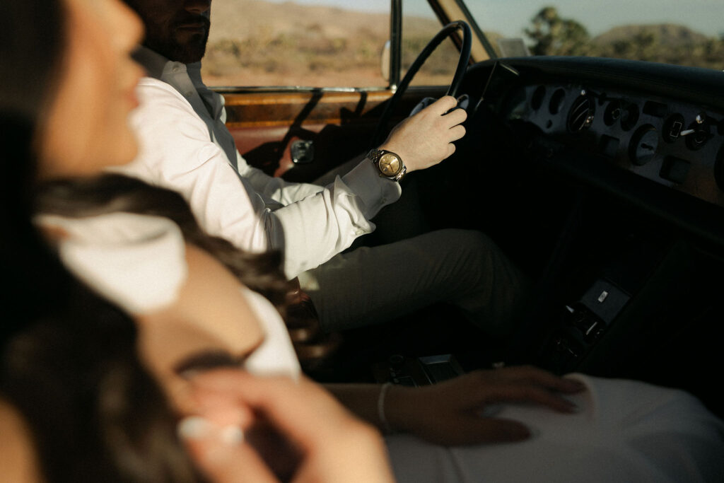 Close up photo of a couple sitting inside of Rolls Royce at Red Rock Canyon