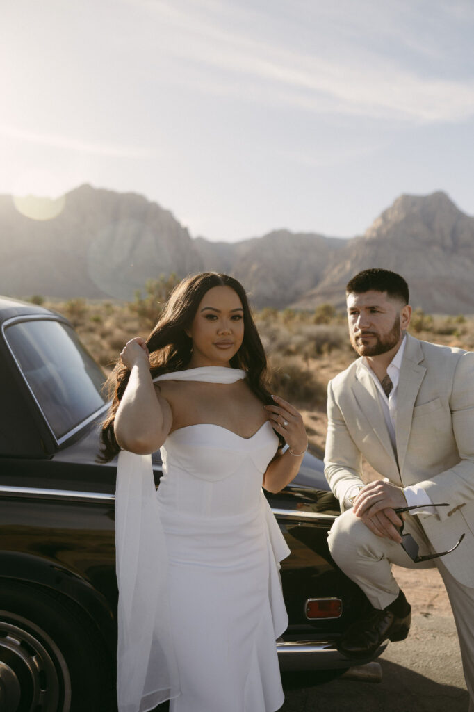 Close-up of woman adjusting her hair and showing her engagement ring during Red Rock Canyon engagement photos.