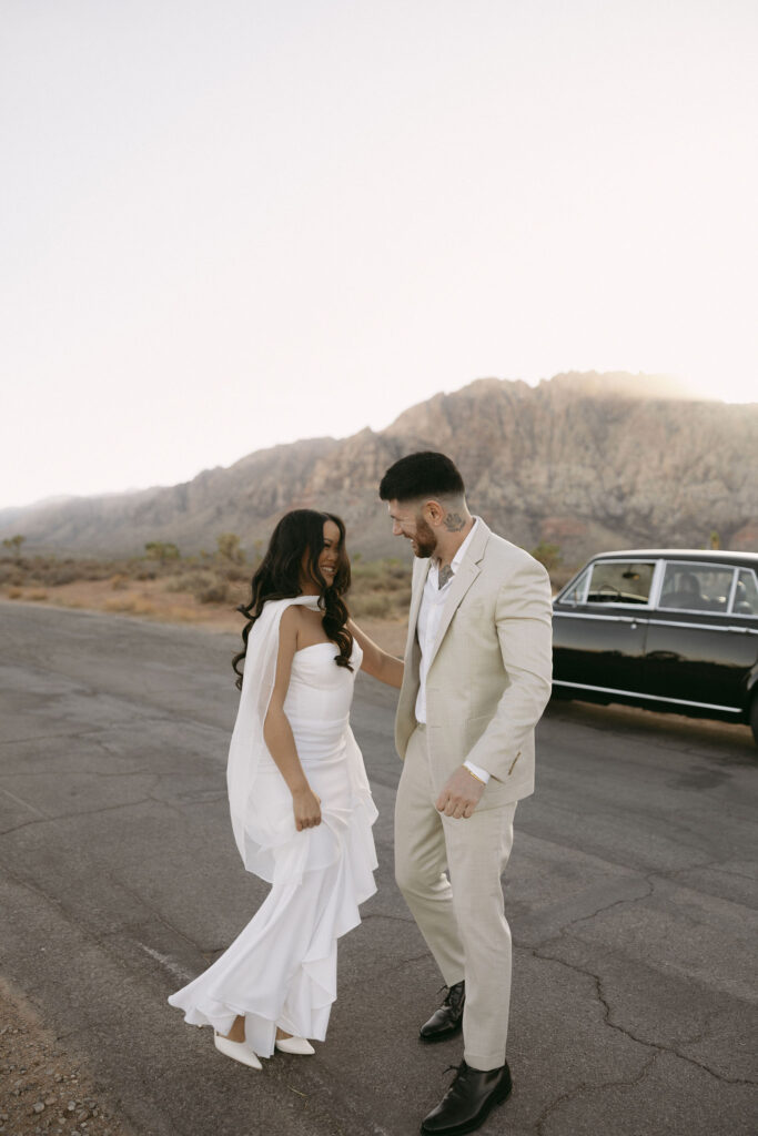 Couple dancing in the road during their cinematic Red Rock Canyon engagement session in Las Vegas