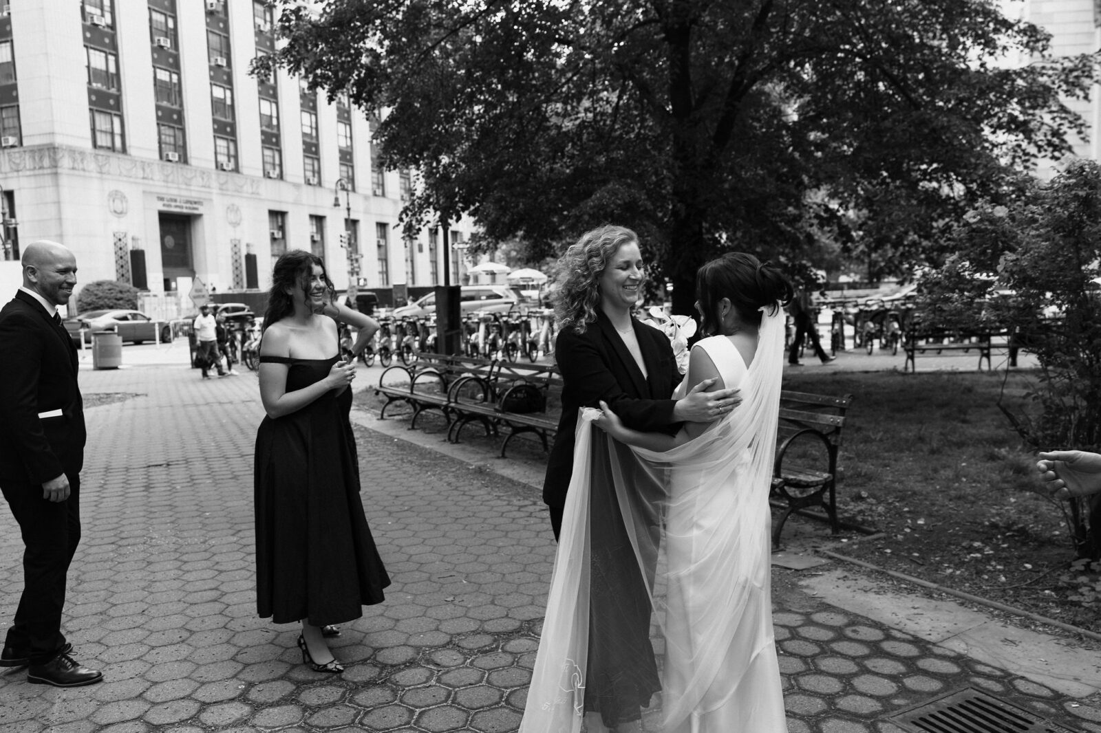 Bride hugging a loved one outside Manhattan City Hall following a New York City Hall elopement ceremony.