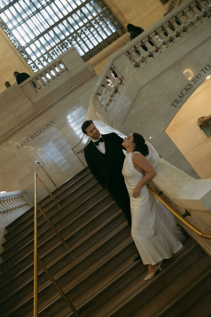 Couple posing on the East Balcony at Grand Central Station during their New York City elopement