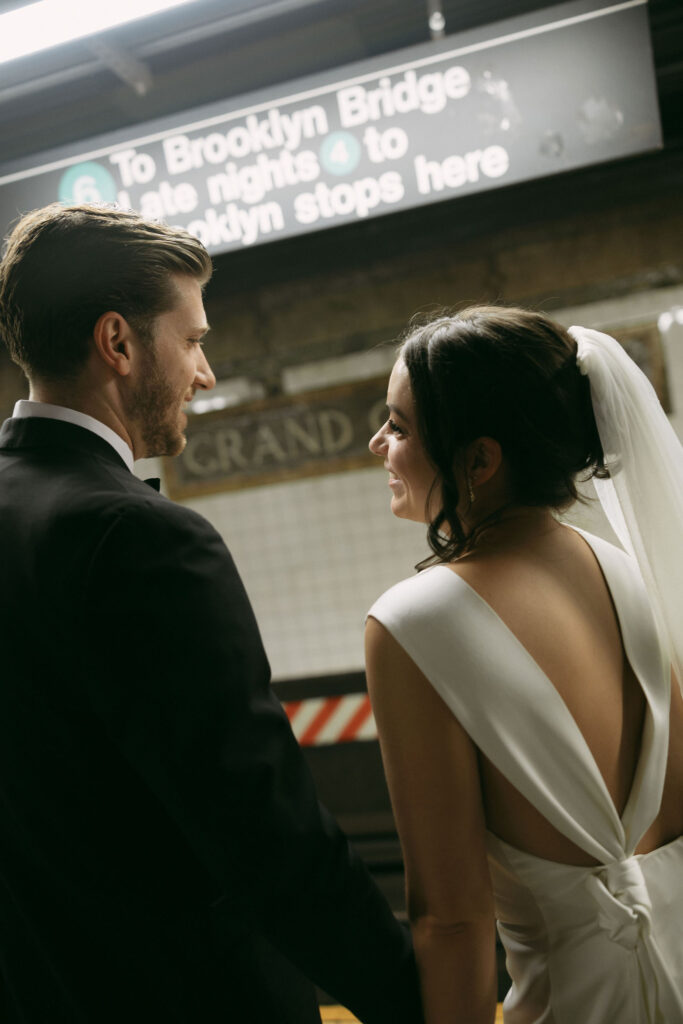 Bride and groom sharing a quiet moment on the subway platform following their New York City Hall elopement.