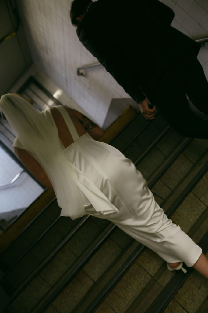 Close up shot of a bride and groom walking up the stairs in NYC.