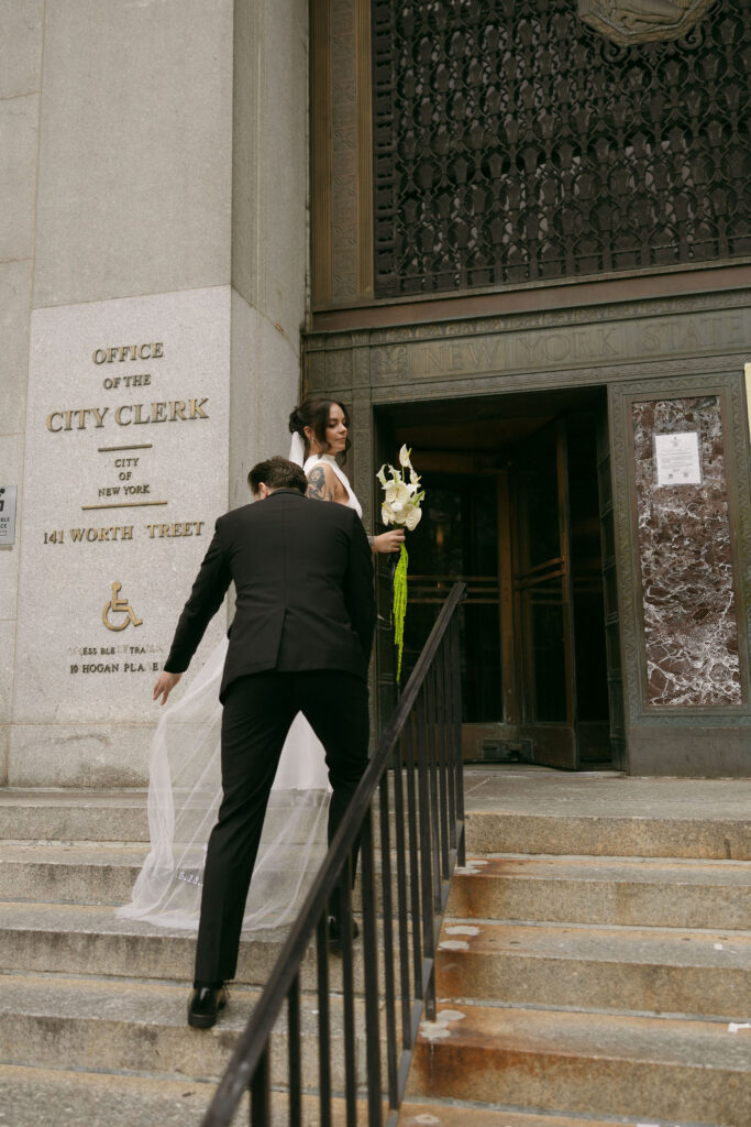 Bride and groom walking into the New York City Clerk at 141 Worth Street.