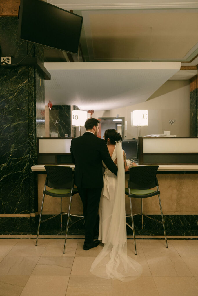 Bride and groom waiting together inside Manhattan City Hall before their New York City Hall elopement ceremony.