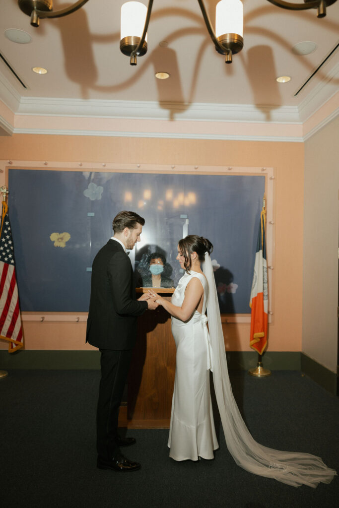 Bride and groom exchanging rings during their New York City Hall elopement ceremony in Manhattan.