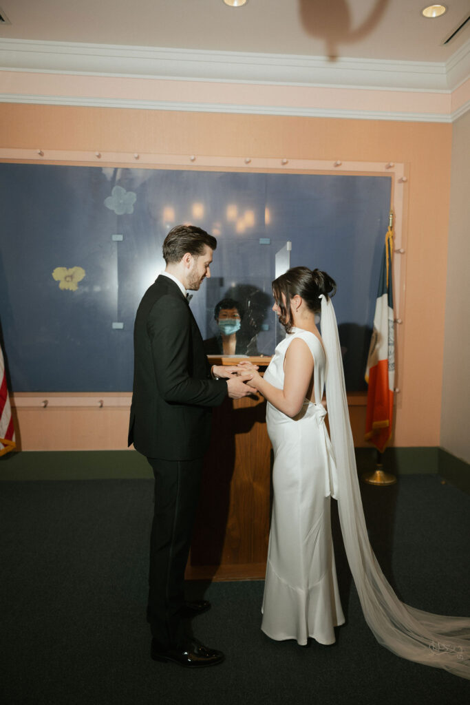 Couple exchanging rings during a New York City Hall elopement inside the Manhattan City Clerk’s office.