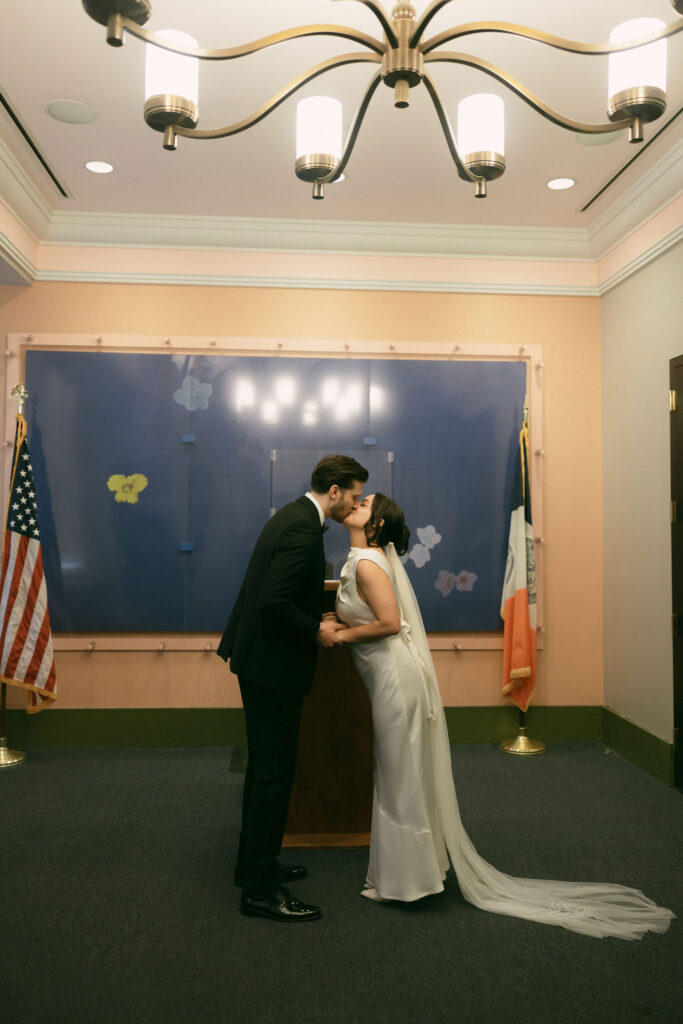 Couple sharing their first kiss during a New York City Hall elopement ceremony in Manhattan.