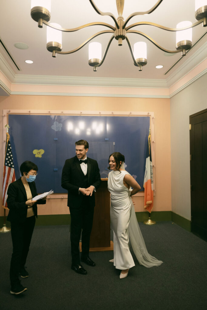 Couple smiling after their New York City Hall elopement ceremony inside a Manhattan ceremony room.
