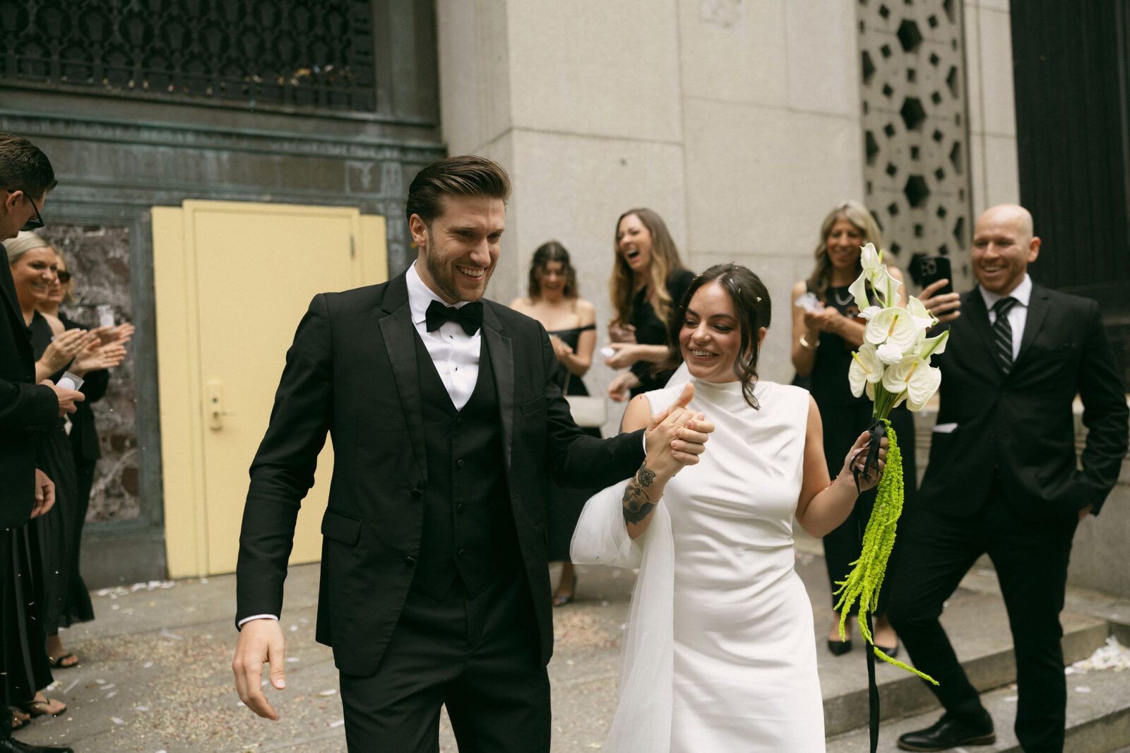 Just married couple celebrating outside Manhattan City Hall after their New York City Hall elopement.
