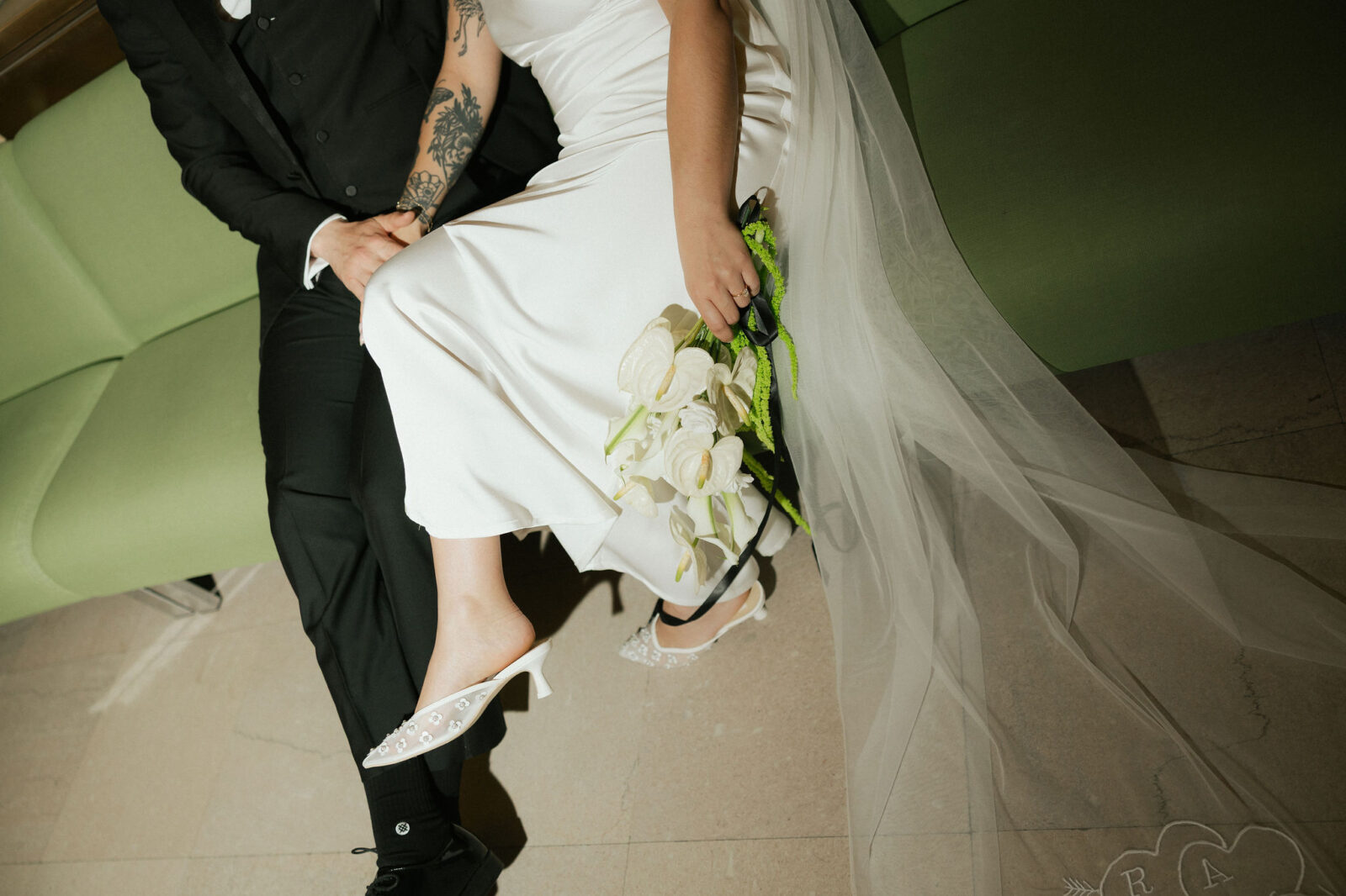 Close up flash photo of a bride and groom sitting together.