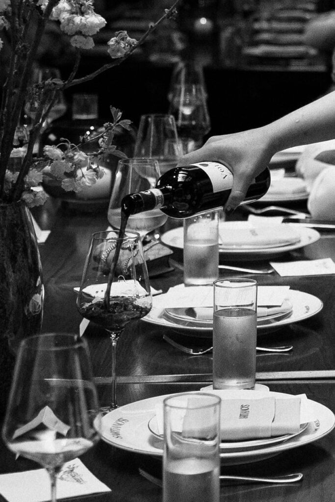 Close-up of wine being poured during an intimate dinner celebration after a New York City Hall elopement.