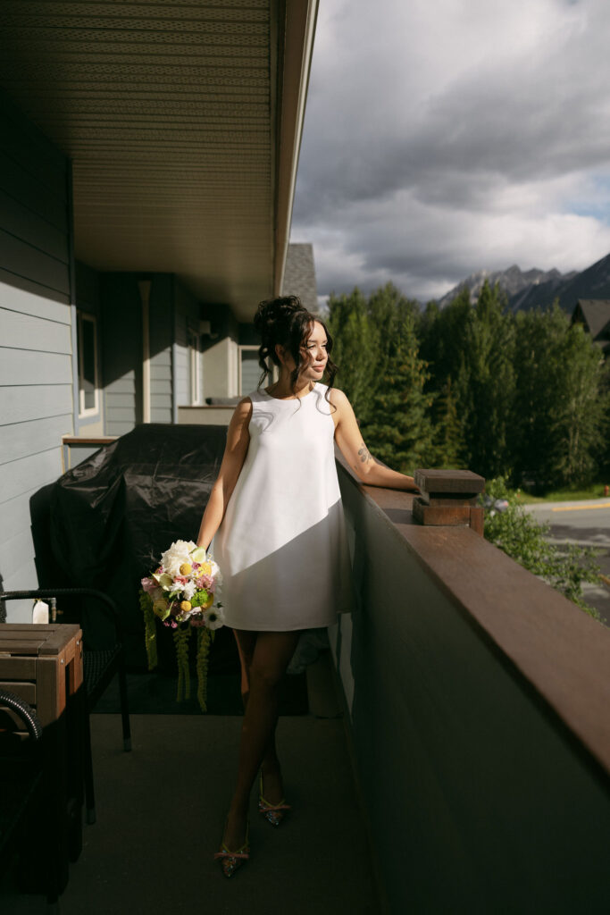 Bride posing in Banff as she gets ready for her intimate elopement.