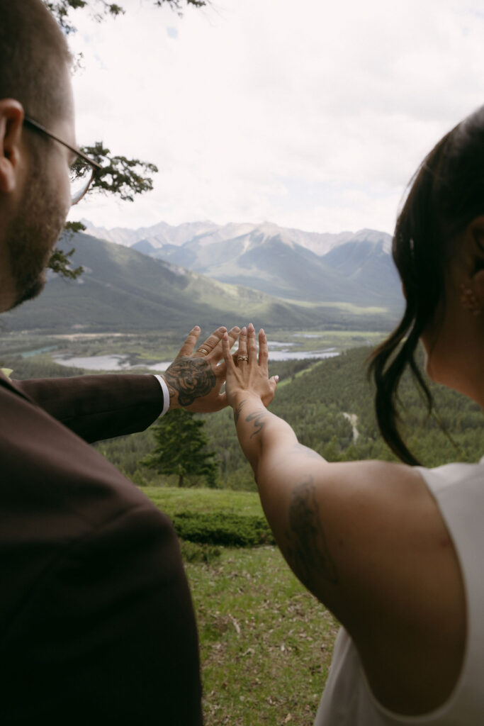 Bride and groom admiring their rings during their Banff National Park elopement photos