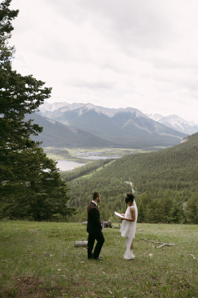Bride and groom exchanging private vows during their Banff National Park elopement.