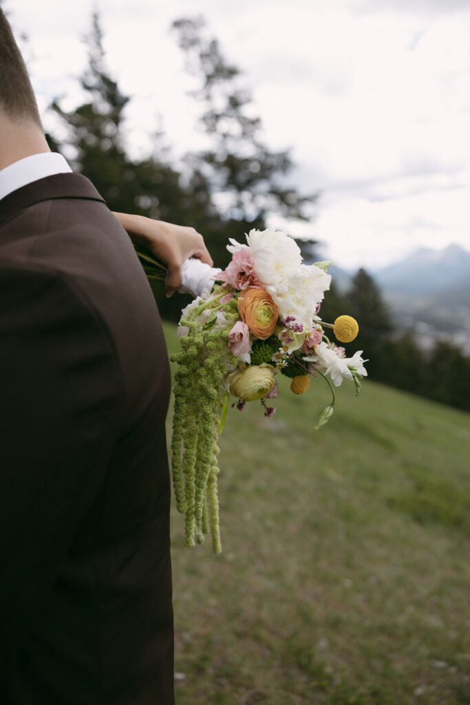 Close up of a bride holding a bouquet during her Banff National Park elopement photoshoot.