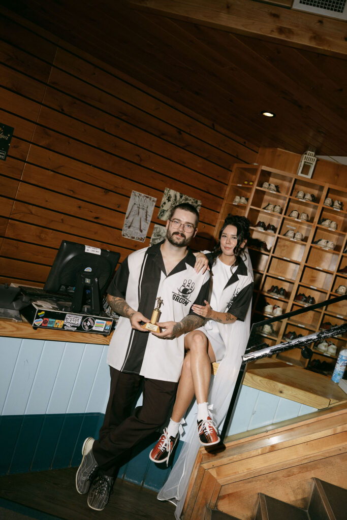 Bride and groom posing at High Rollers during their bowling wedding reception