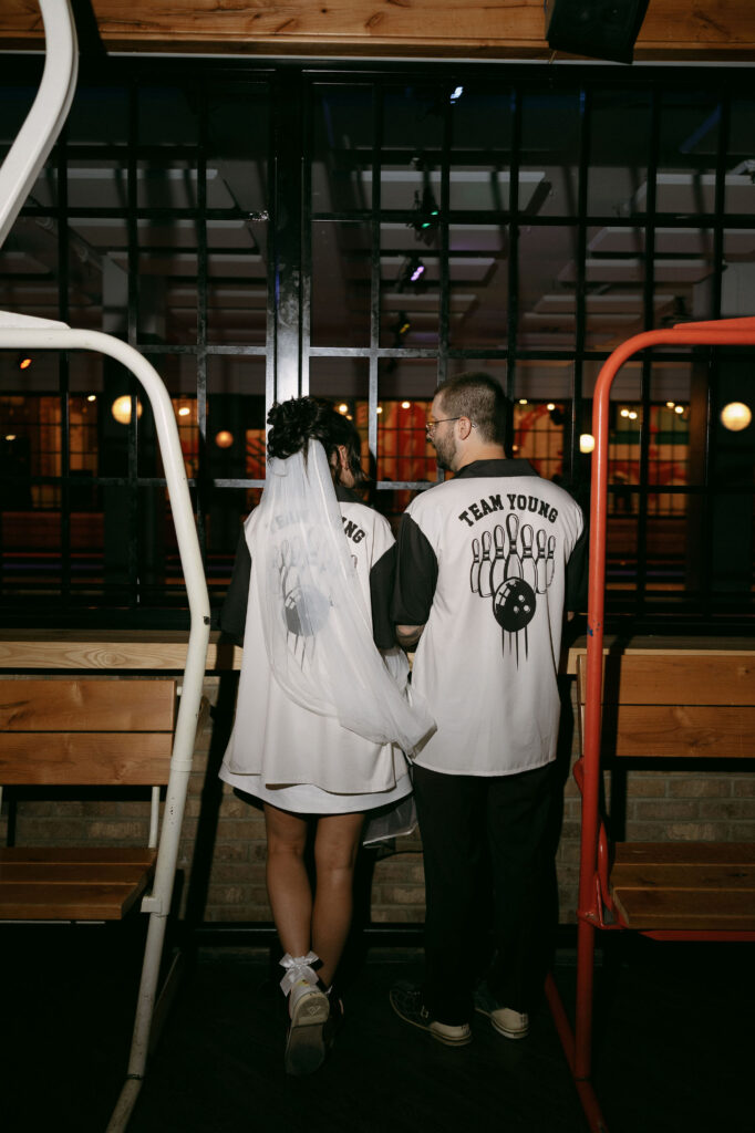 Bride and groom posing at High Rollers during their bowling wedding reception