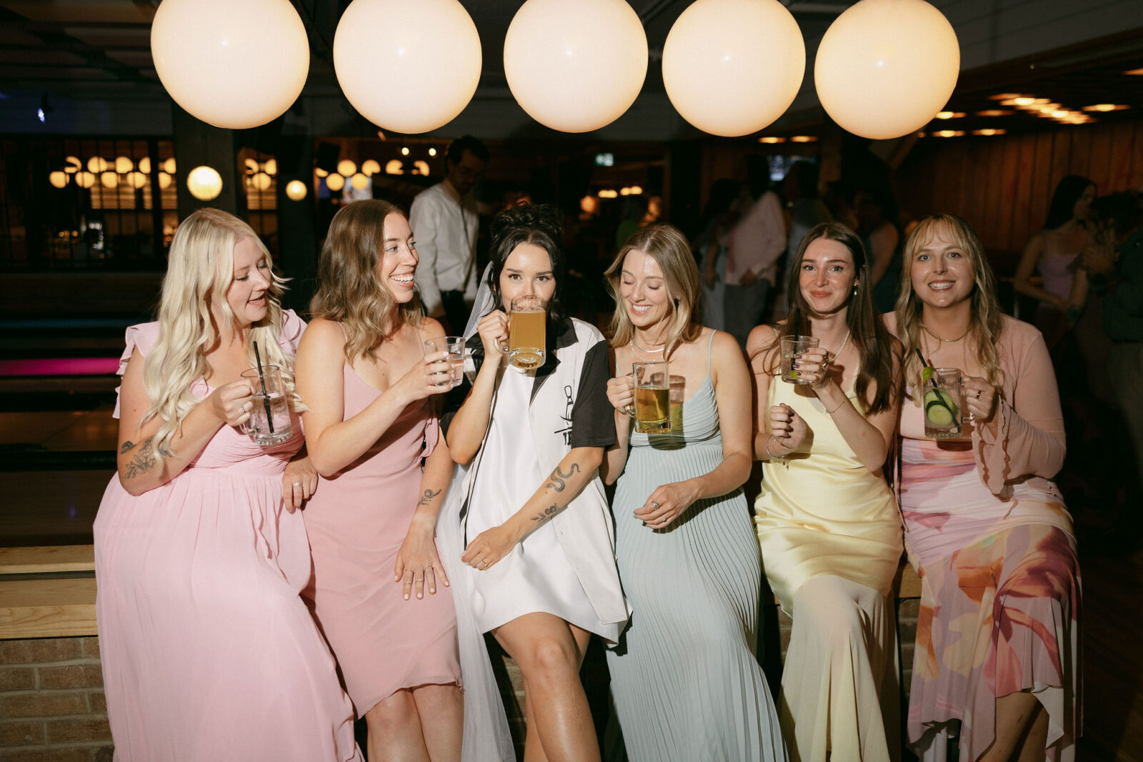 Bride having drinks with friends at High Rollers in Banff.