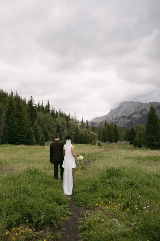 Bride and groom walking the trails during their Banff National Park elopement