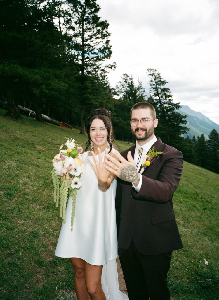 Film photo of a bride and groom posing in Banff National Park